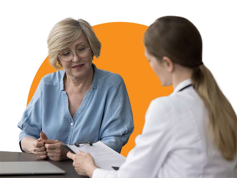 a female doctor goes over a piece of paper with a female 